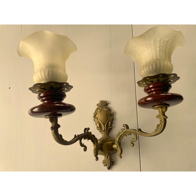 These wall lamps are crafted with decorative brass elements and dark brown ceramic stems. Beautiful opal glass shades with...