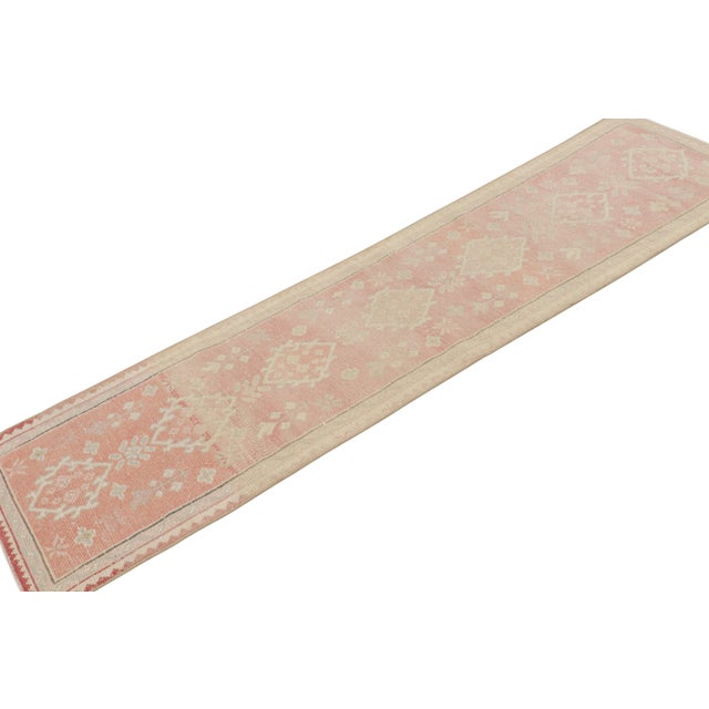 Hand knotted in wool, this 2xx8 vintage Oushak runner rug features intricate geometric patterns in especially rare colors...