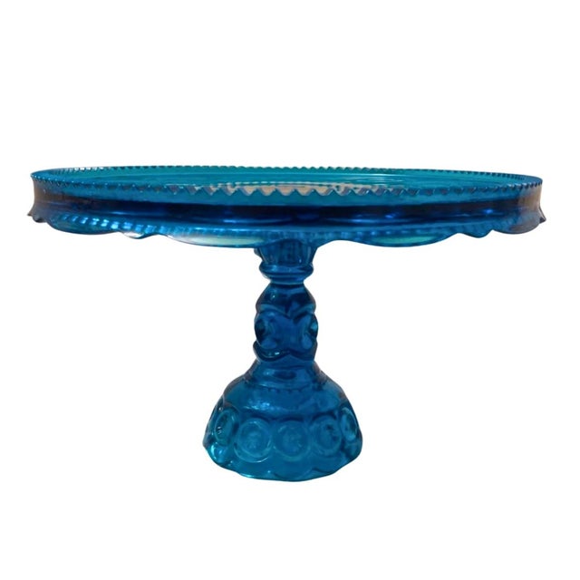 This vintage peacock blue Moon and Stars cake stand is a stunning and rare piece that exudes elegance and charm. Standing...