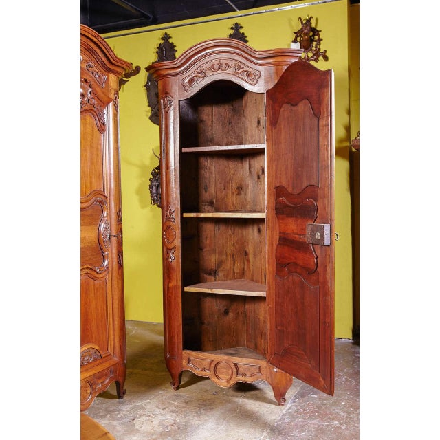 This striking pair of antique French encoignures combines impressive architectural scale with beautifully preserved period...