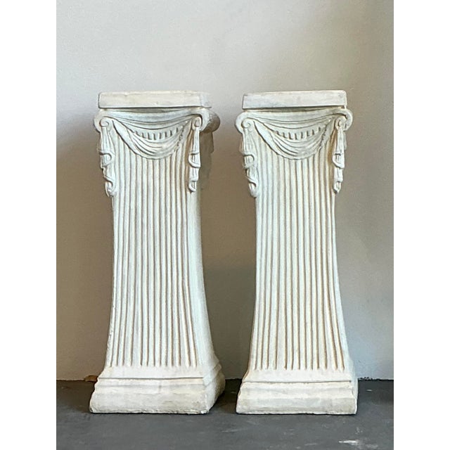 This elegant pair of Neoclassical pedestals brings architectural grandeur and timeless sophistication to any interior....