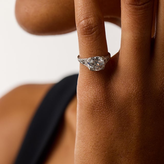 This elegant Art Deco engagement ring centers on a beautiful 1.75 carat old European cut diamond, certified by GIA...
