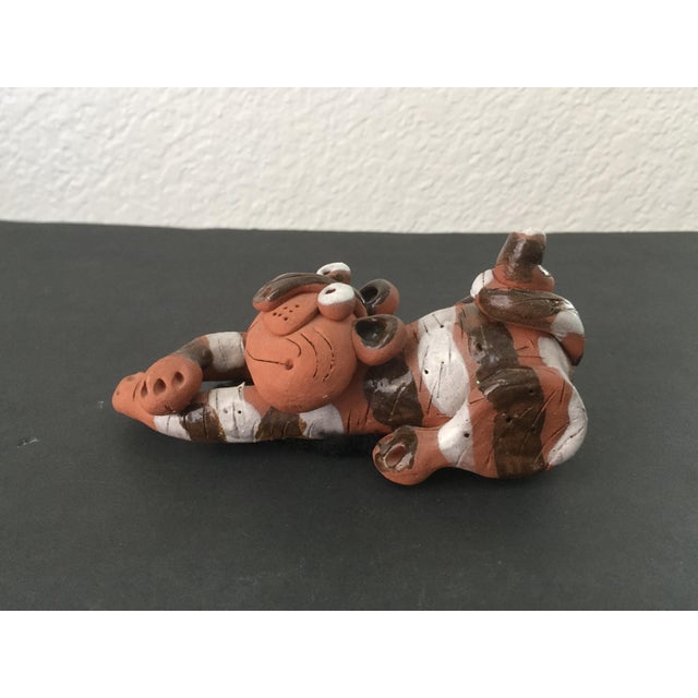 A small Studio Pottery stretching cat sculpture. Measurements 5" x 2-1/4" x 2-1/2" tall Net weight 9.50 oz