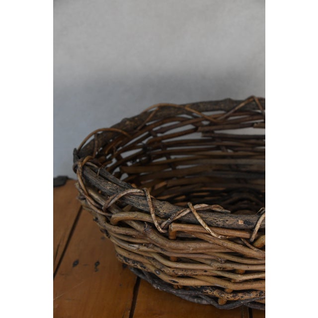 A handwoven grapevine basket with a beautifully rustic form. Its organic texture and timeworn character make it wonderful...