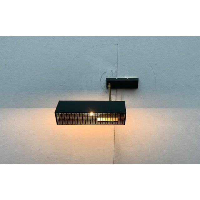 Mid-Century wall lamp with flexible umbrella. Probably from Emperor. A minimalist design. Cubic shapes run through this...