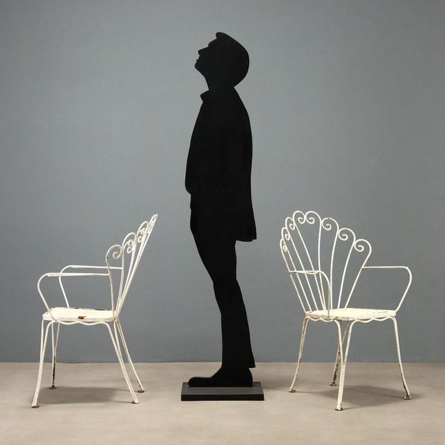 Set of four garden chairs from the 1950s-60s, crafted in white lacquered iron. These chairs feature an elegant design with...