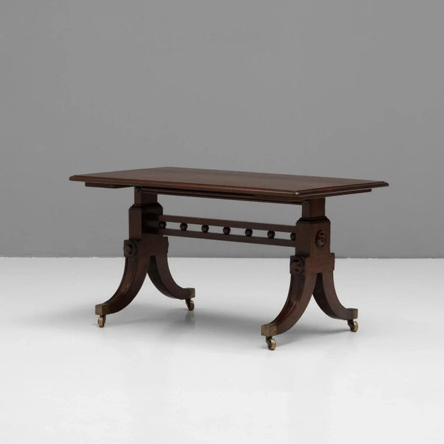 Mahogany coffee table on splay legs and brass casters. Circa 1830 ( Diminished height ).