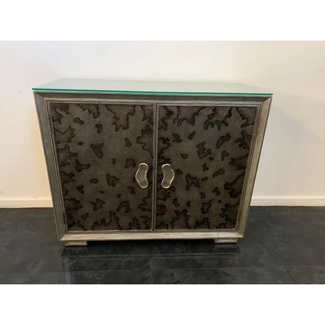 Exceptional example of high decoration the body and covered in glossy metal leaf, the central doors filled with small half...