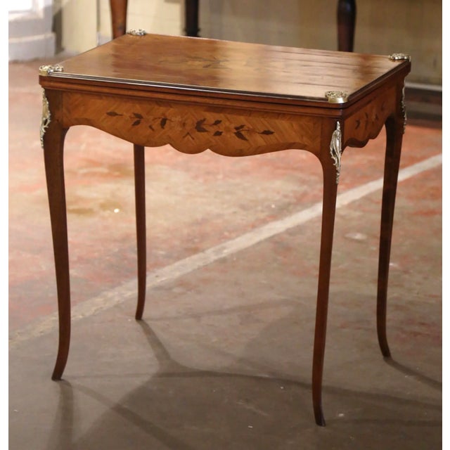 Combining fine craftsmanship with practical versatility, this antique French Louis XV style game table features intricate...