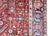 This antique Persian Heriz rug, dating to the 1920s, features a bold geometric design with a prominent central medallion....