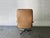 A distinctive 1970s swivel reclining armchair, upholstered in the original tan leather on a polished chrome tubular frame...