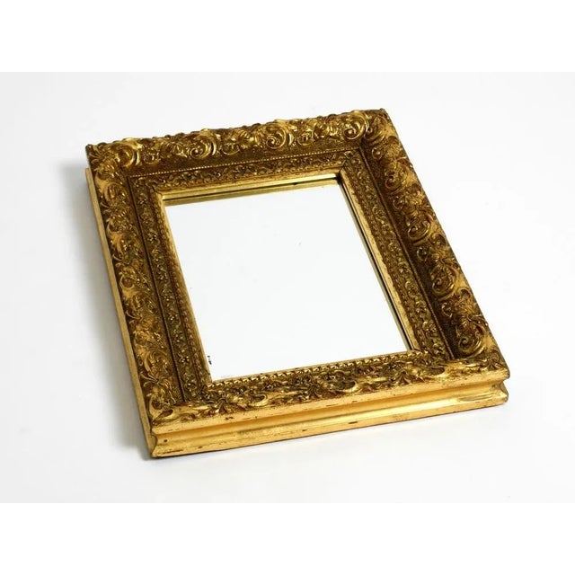 Beautiful rare Mid Century wall mirror made of ornate solid wood. The frame is completely gold-plated and has a wonderful...