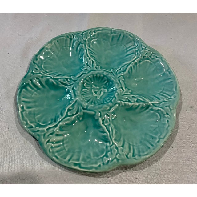 A beautiful mid-century French majolica oyster plate crafted by the historic Faïencerie de Gien. This earthenware plate...