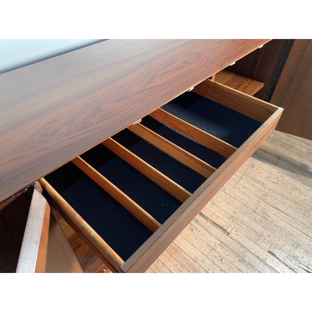 A Vintage Exotic wood sideboard cabinet by Milo Baughman for Directional. One of the doors needs an adjustment to properly...