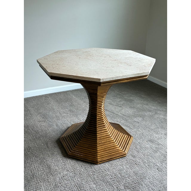 Sophisticated Bunny Williams Home accent table featuring a dramatic sculptural hourglass pedestal base in a warm antiqued...