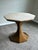 Sophisticated Bunny Williams Home accent table featuring a dramatic sculptural hourglass pedestal base in a warm antiqued...