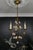 - Italian Florentine golden color metal and porcelain three-light chandelier from the circa 1970s. - This adorable...