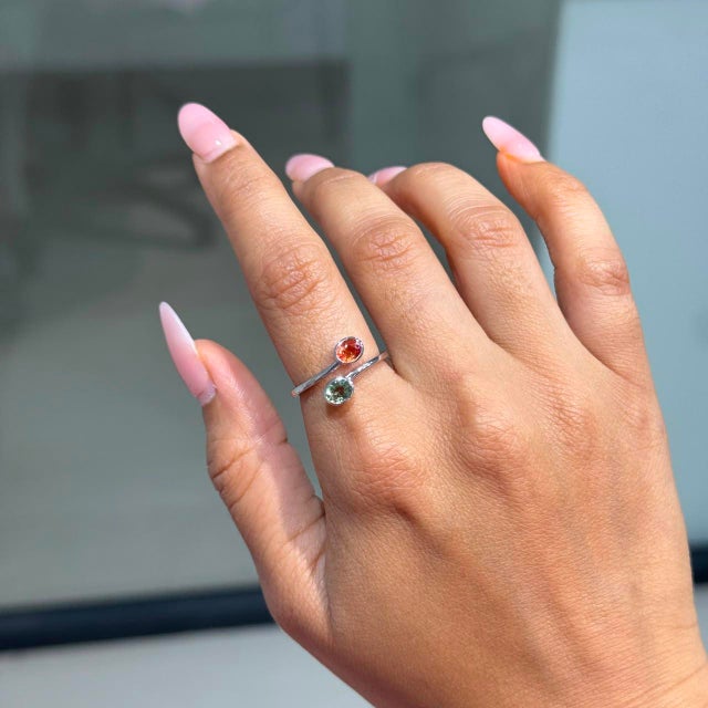 This Toi et Moi open bypass ring showcases 0.8 carats of two vibrant natural sapphires set in 14k white gold. Each...