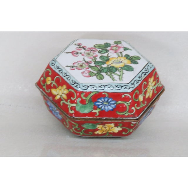 This lovely Trinket Box is made of metal. This charming little box features a wonderful hexagon shape, multi color flowers...