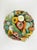 A charming and whimsical Italian ceramic centerpiece basket, featuring a colorful array of sculpted vegetables. This...
