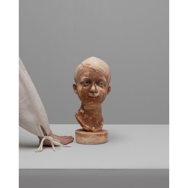 This 1920s French plaster bust of a boy captures the quiet sensitivity and naturalism characteristic of early 20th-century...