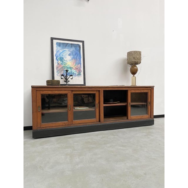 Old craft sideboard from the 1950s in solid oak with sliding glass doors. We love the elegance of this piece of furniture,...