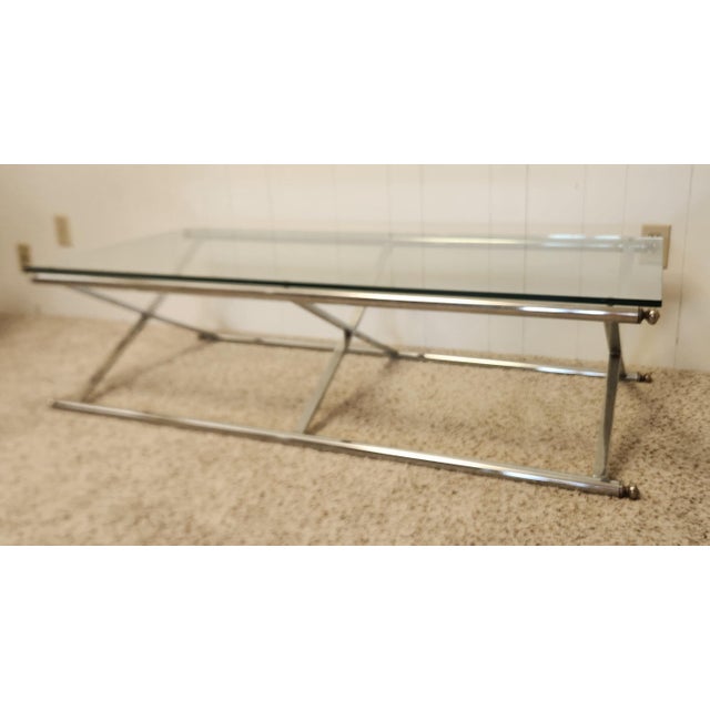 spare, elegant and contemporary 1970s modern cocktail table, often attributed to Maison Jensen, four tubular chrome...