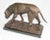 A french bronze figure of a dog. Early 20th century. Dark brown patination. Shown standing with head sniffing the ground....