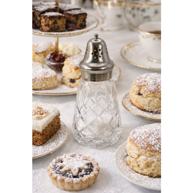 An elegant Victorian silver plate and cut glass sugar sifter, dating to the late 19th century. This classic table...