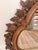 Striking vintage walnut wall mirror featuring an ornate dimensional frame richly decorated with carved fruit, flowers,...