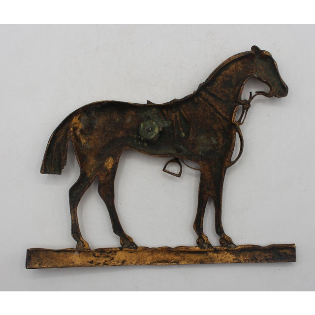 Gilt bronze horse silhouette, late 19th-early 20th century, Anglo-American. Horse standing in a leafy pasture with saddle...