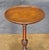 A fine English wine or cocktail table of mahogany from the Edwardian era, featuring a raised edge around the circumference...