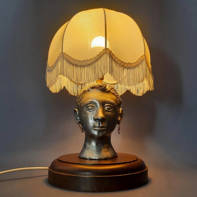 Special vintage table lamp sculpture, depicting a woman's head, handcrafted from aluminum in a classic tribal/retro style,...