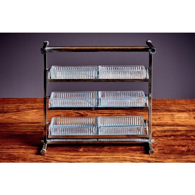 Refined French mid-century étagère composed of a chrome-plated steel frame with three tiers of removable pressed-glass...