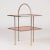 This Swedish functionalist side table features light graphic lines and is made from metal and red-lacquered wood. The...