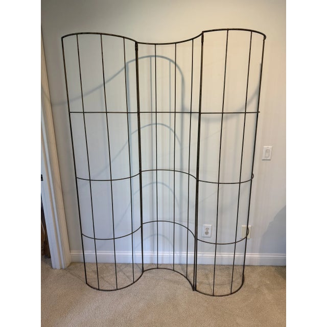 Interesting 3 panel iron screen in a serpentine shape that folds into itself for easy storage. Can be used indoors or out....