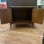 A faux bamboo nightstand by Stanley Furniture, circa 1970s. Two cabinet doors fronted in woven cane with Greek key...