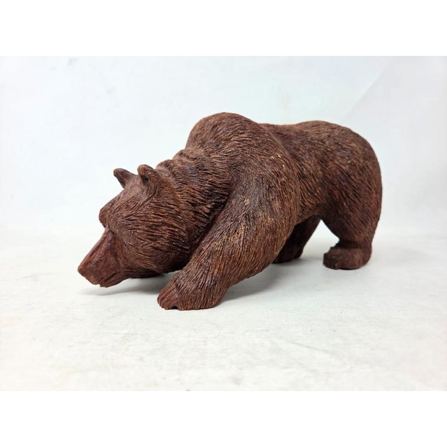 Here is a vintage 1960s signed hand carved wood Grizzly bear. The bear is walking with its head down as if it's sniffing...