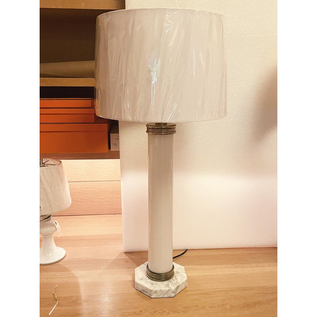 Made in the 1960s, these Italian table lamps consist of white glass bodies, octagonal marble bases, and brass trims. They...