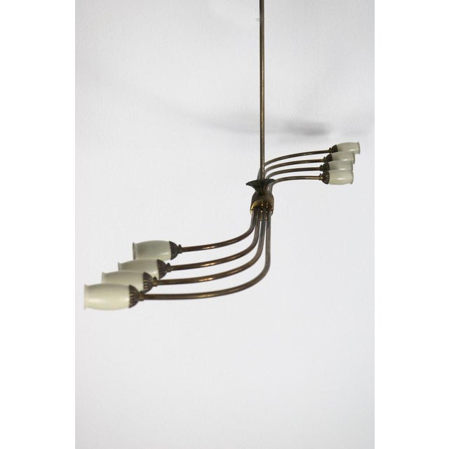 Italian hanging lamps from the 1950s. The lamp itself is made of brass and has 8 small aluminum umbrellas attached to the...