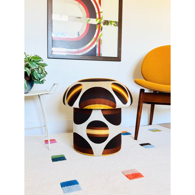 A handmade mushroom shaped ottoman, upholstered in vintage mid century fabric. Fabric is a synthetic material with a bold...