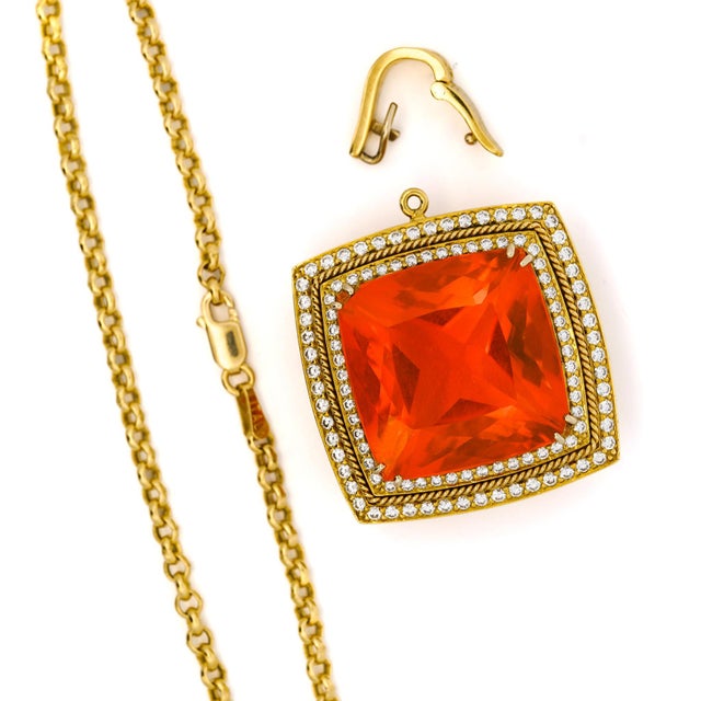 Vintage circa 1980s–1990s cocktail necklace features a GIA-certified 20.61-carat natural orange opal cushion cut, set in...