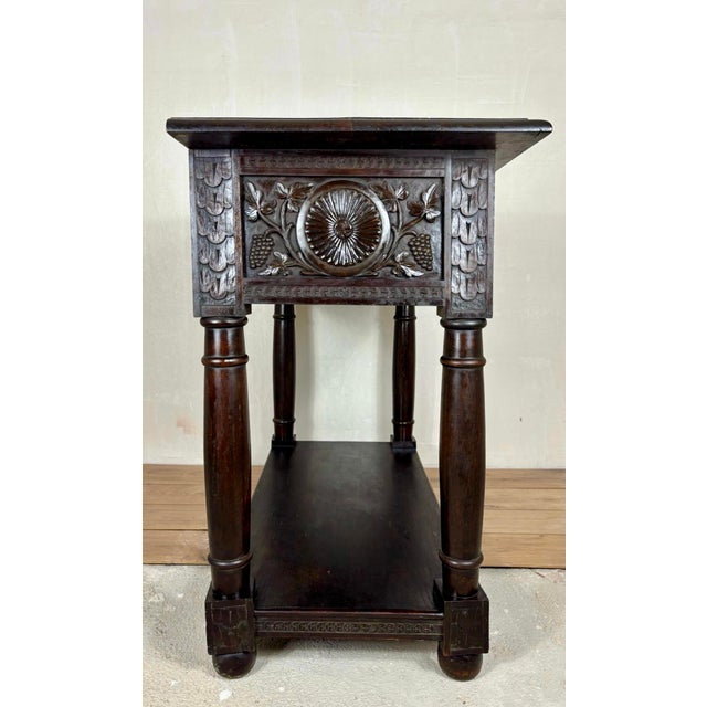 Impressive 19th century Spanish console table crafted in solid oak, featuring richly carved drawer fronts with floral and...