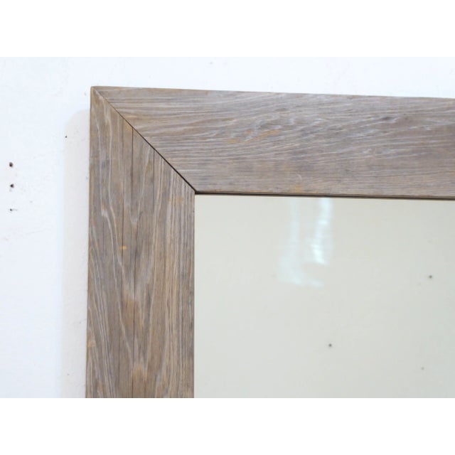 This weathered wood mirror measures 46.5"H x 39.5"W and is set up to hang vertically, but you can change the hangers for...