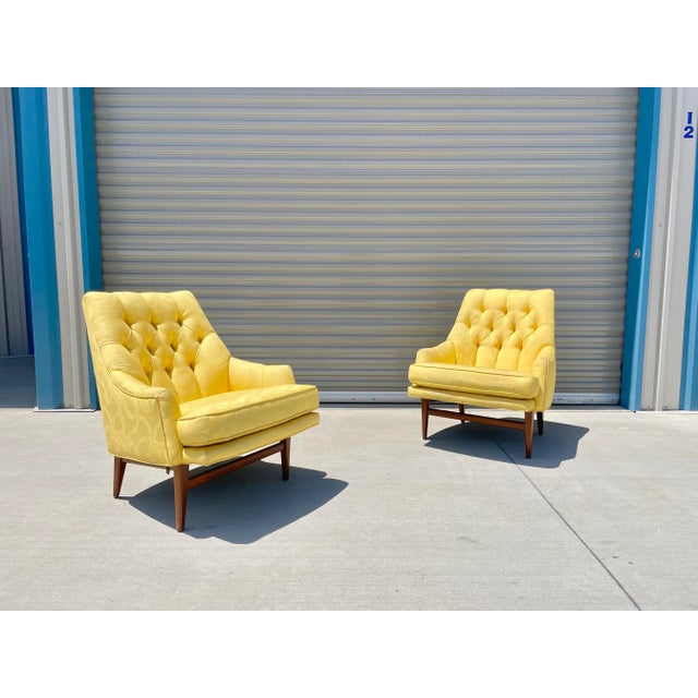 This vibrant pair of mid-century high-back lounge chairs captures the sculptural elegance and architectural stance styled...