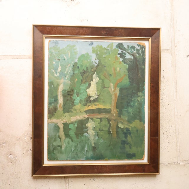 20th Century French Green Forrest Painting offers an inviting woodland scene rendered in soft, layered shades of green,...