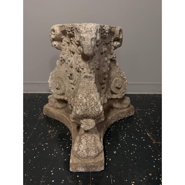 Large and substantial cast stone architectural capital featuring sculptural ram head motifs, curled horns, floral details,...