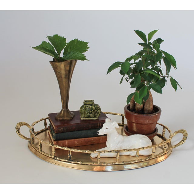 Large vintage faux bamboo brass tray with handles. No makers mark. Some patina to brass. Dents on bottom rim.