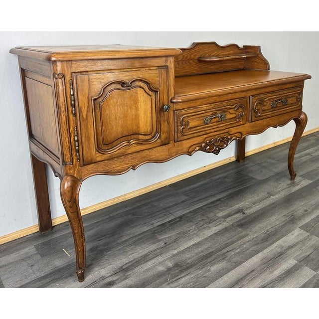 This charming Vintage French Louis style bench cabinet combines elegant proportions with practical storage, featuring a...