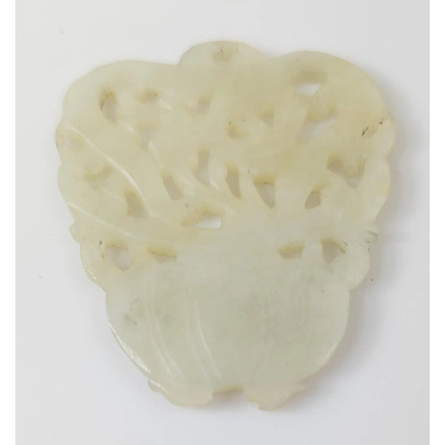 We are selling this simple Chinese 20th century carved nephrite jade plaque with flower basket form carved from a...